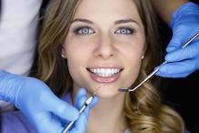 Woman smiling while being examined by dentist